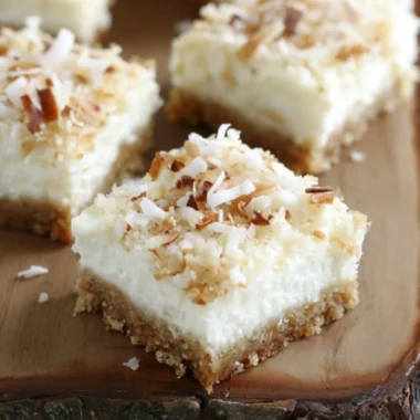 Skinny coconut cheesecake bars on a serving plate