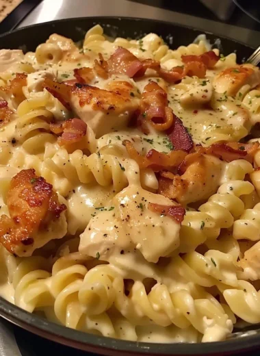 Delicious Chicken Bacon Ranch Pasta served in a bowl with herbs and cheese.