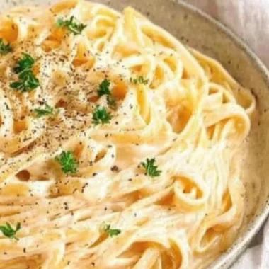 Creamy Fettuccine Alfredo pasta with Parmesan cheese and parsley garnish