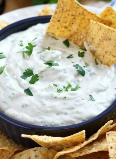 Bowl of homemade ranch dip with fresh vegetables for dipping