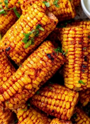 Delicious roasted corn ribs served on a rustic wooden plate