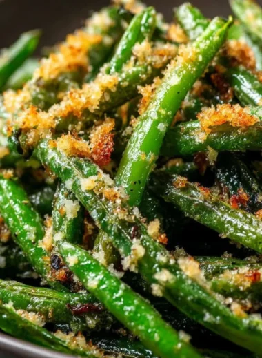 Plate of roasted green beans with garlic and parmesan topping