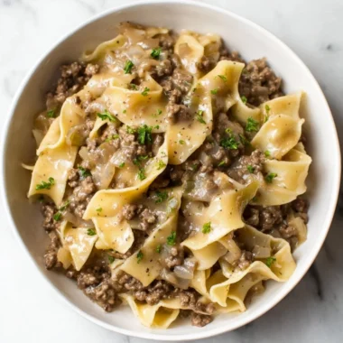 Simple beef and noodles dish served in a bowl with vegetables.