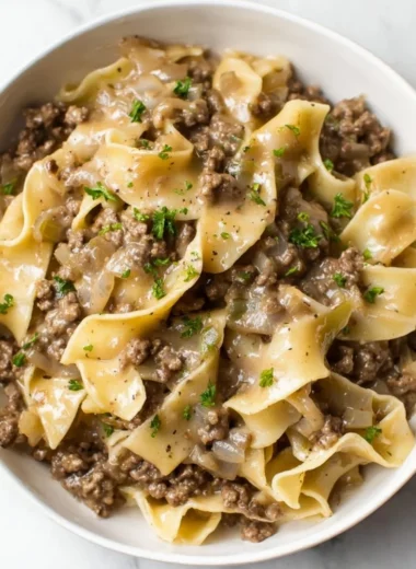 Simple beef and noodles dish served in a bowl with vegetables.