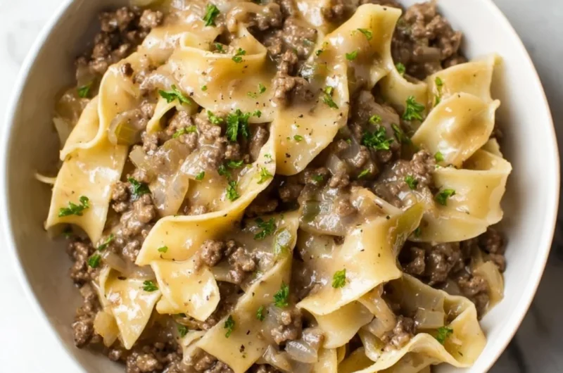 Simple beef and noodles dish served in a bowl with vegetables.