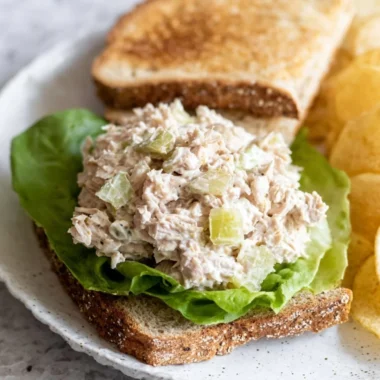 Delicious tuna salad sandwich with fresh ingredients and vibrant presentation.