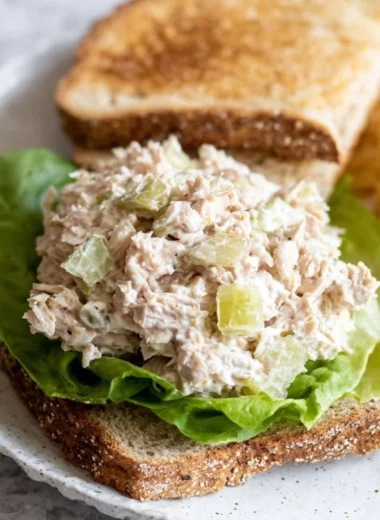 Delicious tuna salad sandwich with fresh ingredients and vibrant presentation.