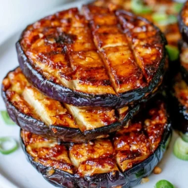 Crispy air fryer eggplant served on a plate with herbs