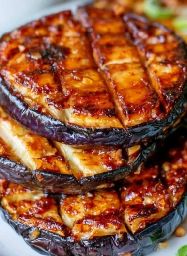 Crispy air fryer eggplant served on a plate with herbs