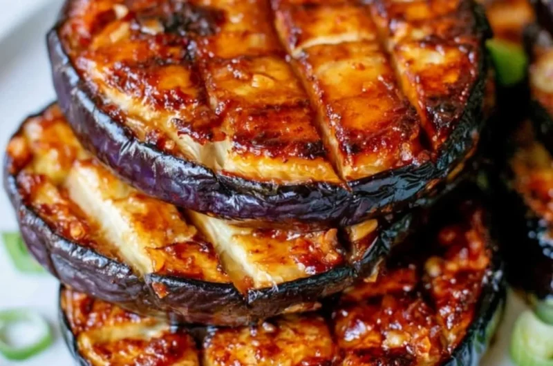 Crispy air fryer eggplant served on a plate with herbs