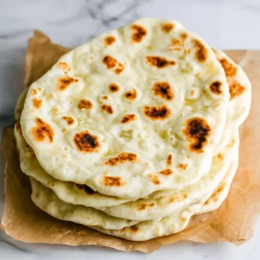 Homemade Greek Pita bread fresh from the oven, ideal for Mediterranean dishes.