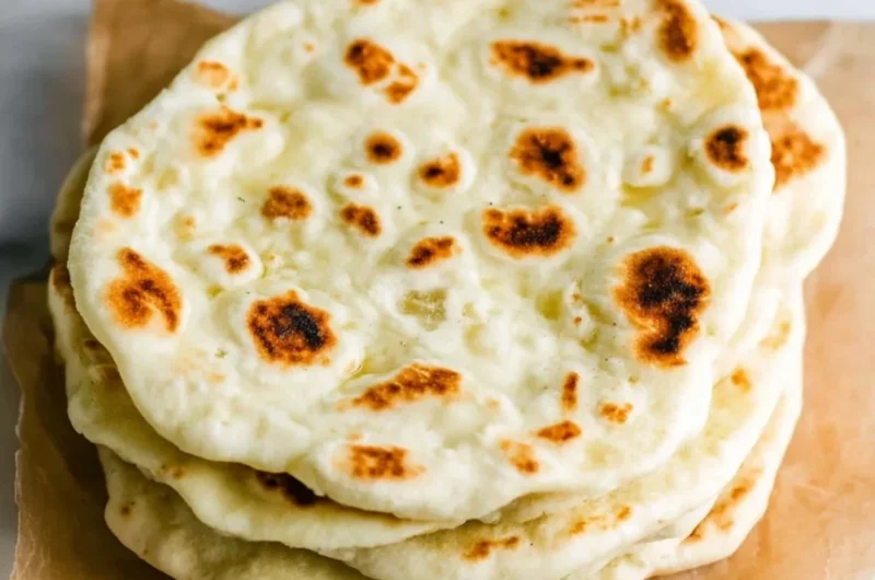 Homemade Greek Pita bread fresh from the oven, ideal for Mediterranean dishes.