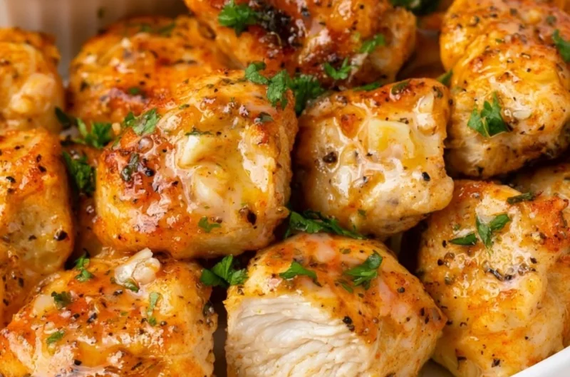 Plate of delicious buttery chicken bites garnished with herbs