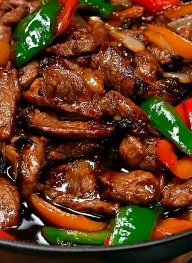 Chinese pepper steak with onions served in a vibrant bowl