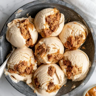 Creamy cookie butter ice cream in a bowl topped with cookie crumbles