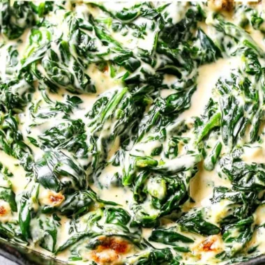 Delicious bowl of creamed spinach garnished with herbs