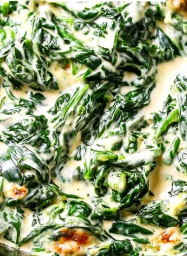 Delicious bowl of creamed spinach garnished with herbs