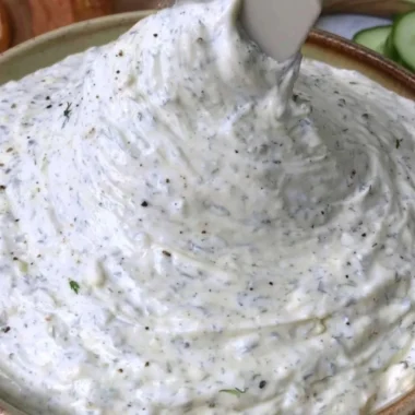 Fresh Cucumber Dip served in a bowl with colorful vegetables on the side.