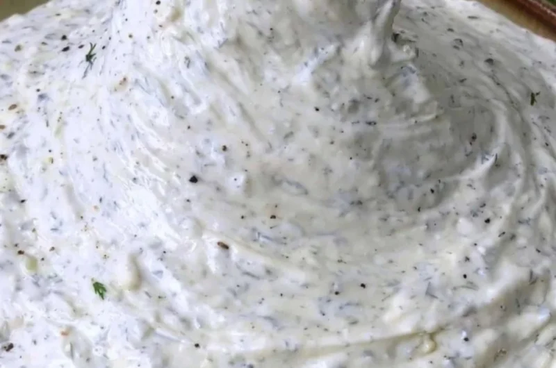 Fresh Cucumber Dip served in a bowl with colorful vegetables on the side.