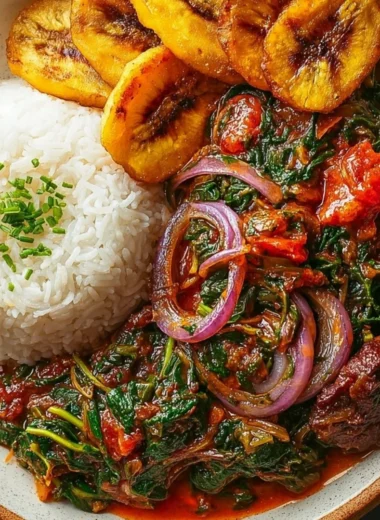 A bowl of Ghanaian Spinach Stew garnished with herbs and spices.