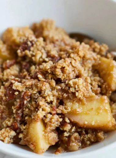 Healthy breakfast apple crumble topped with oats and fresh apples