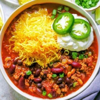 Bowl of healthy turkey chili topped with fresh herbs and spices