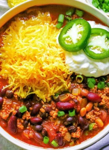 Bowl of healthy turkey chili topped with fresh herbs and spices