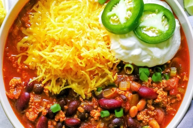 Bowl of healthy turkey chili topped with fresh herbs and spices