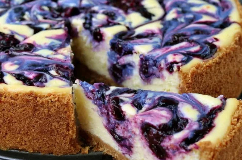 Lemon Blueberry Cheesecake topped with fresh blueberries and lemon zest.
