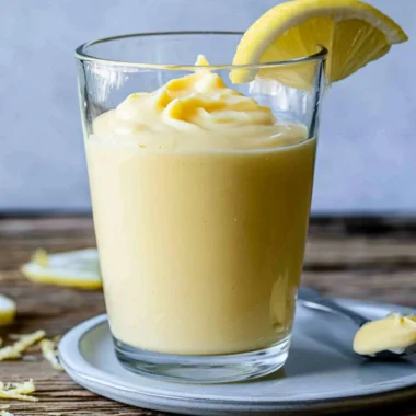 Delicious lemon cream dessert served in a bowl with fresh lemon slices.