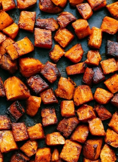 Plate of colorful roasted vegetables including carrots, bell peppers, and zucchini.