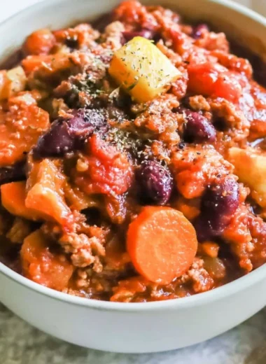 Bowl of Turkey Apple Chili garnished with fresh herbs