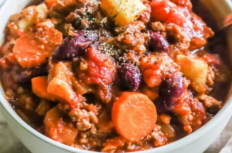 Bowl of Turkey Apple Chili garnished with fresh herbs