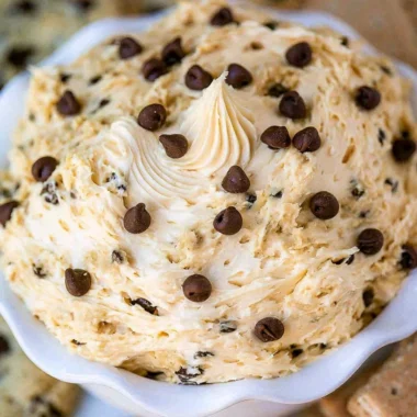 Bowl of chocolate chip cookie dough dip with chocolate chips on top