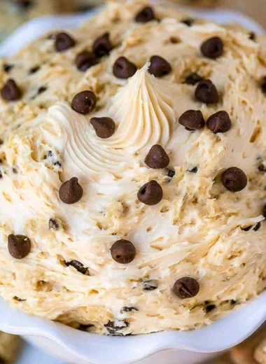 Bowl of chocolate chip cookie dough dip with chocolate chips on top