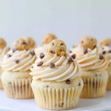 Cozy cookie dough cupcakes topped with creamy frosting and chocolate chips