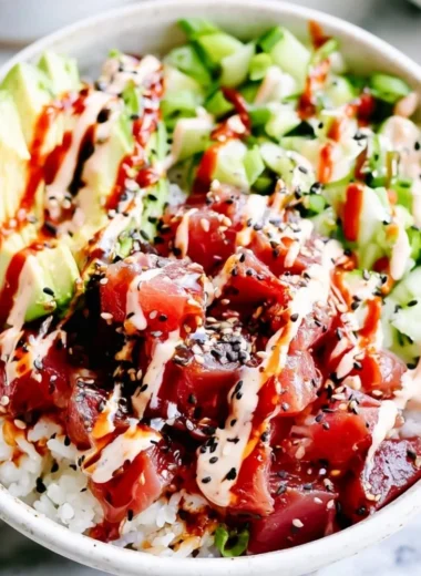 Cozy spicy tuna poke bowl topped with fresh ingredients and a spicy sauce