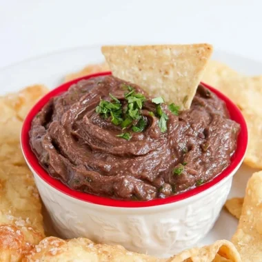 Quick and easy vegan black bean dip served in a bowl with tortilla chips