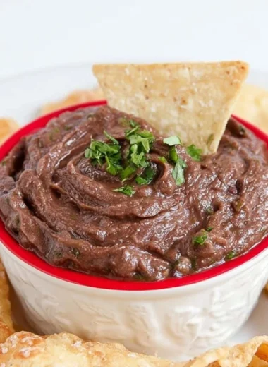 Quick and easy vegan black bean dip served in a bowl with tortilla chips