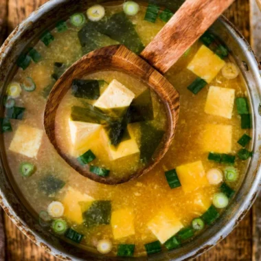 Bowl of homemade miso soup with tofu, scallions, and seaweed