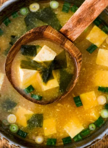 Bowl of homemade miso soup with tofu, scallions, and seaweed