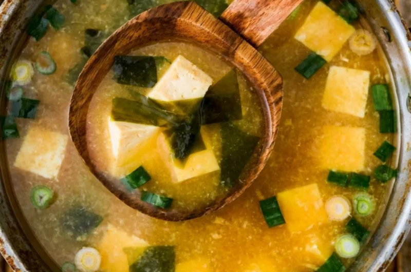 Bowl of homemade miso soup with tofu, scallions, and seaweed