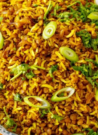 Bowl of Mediterranean lentils and rice with fresh herbs and vegetables