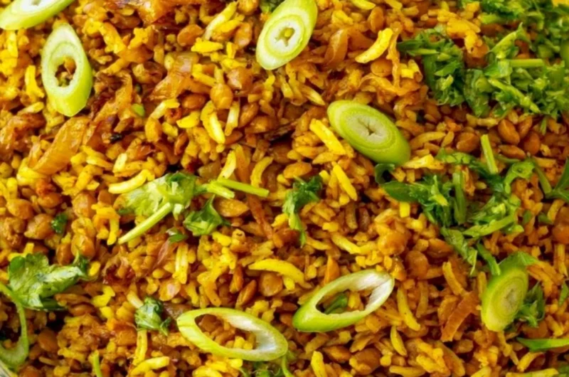 Bowl of Mediterranean lentils and rice with fresh herbs and vegetables