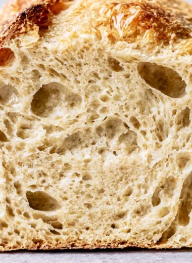 Freshly baked sourdough bread loaf on a wooden table